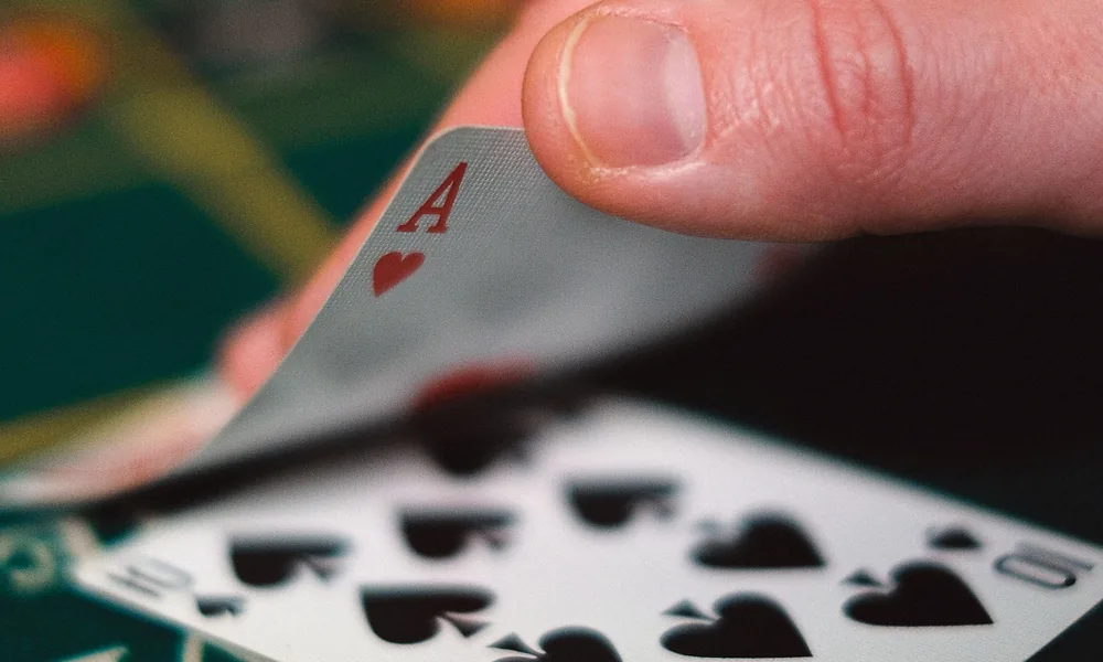 Dealer handling playing cards for the bet22 Dragon Tiger guide