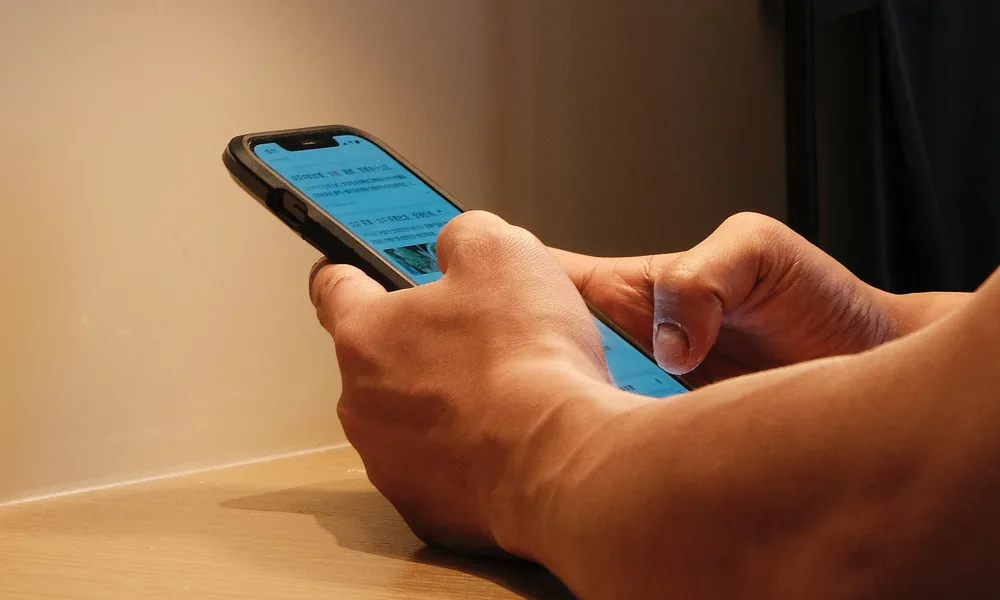 Hands using a smartphone for mobile app access guidance