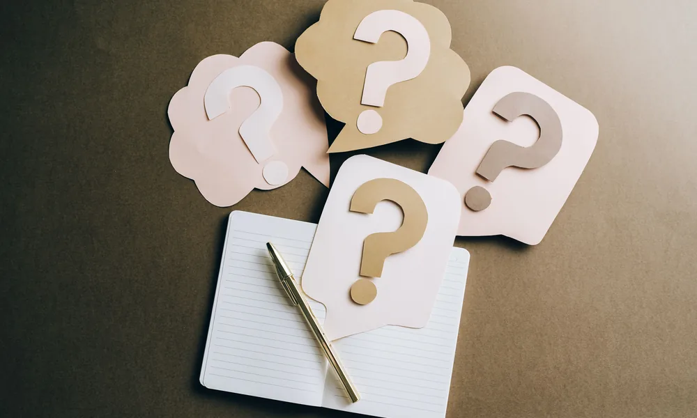 Question mark notebook representing common bet22 guide questions