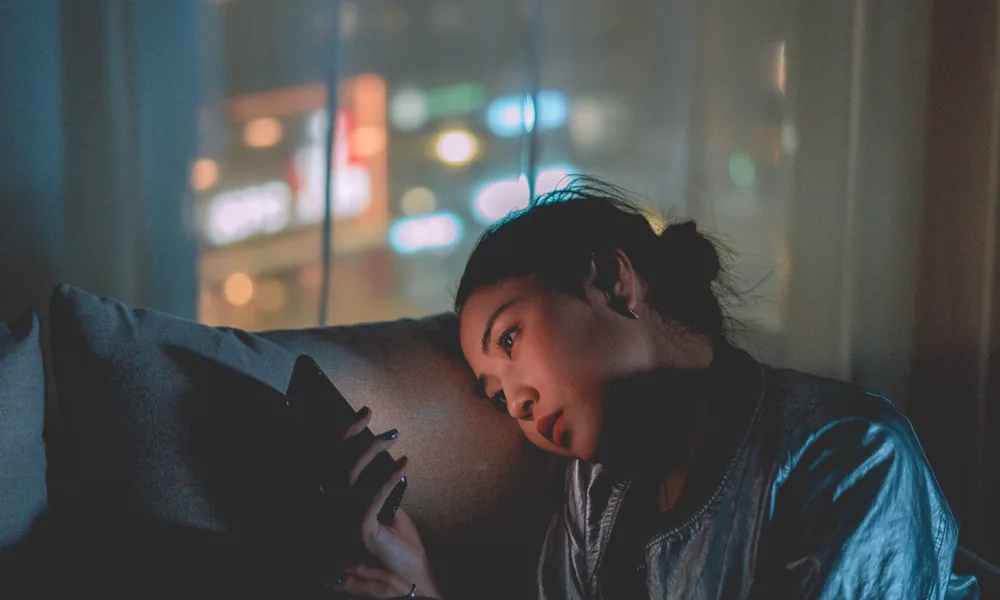 Person checking a smartphone at night for the bet22 India guide
