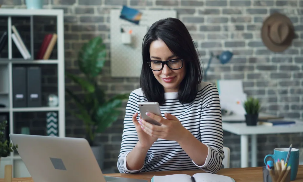 Generic user reviewing mobile guidance at an office desk